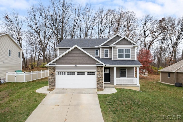 craftsman-style house featuring a garage, covered porch, and a front lawn