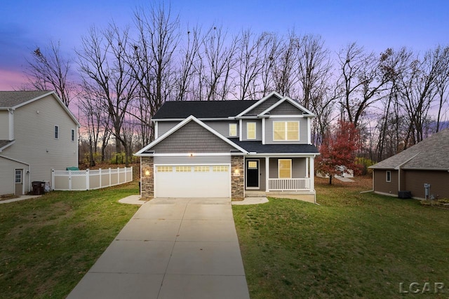 craftsman-style home with a porch, a garage, and a lawn