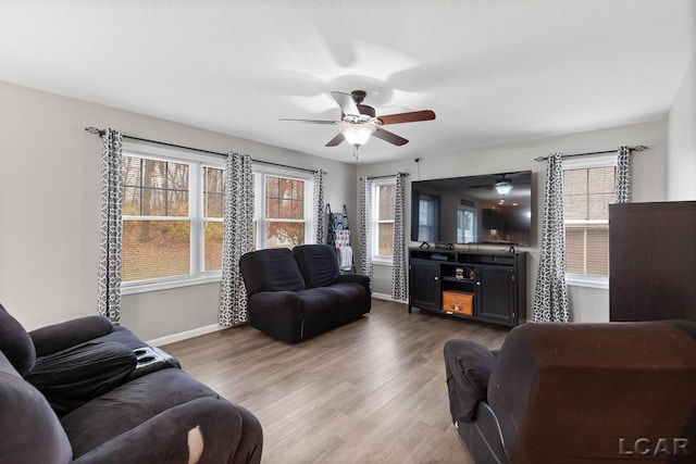 living room featuring hardwood / wood-style flooring, plenty of natural light, and ceiling fan