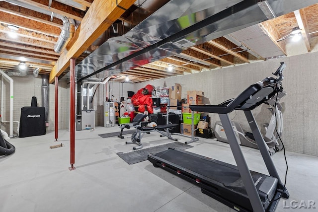 workout room featuring heating unit and water heater