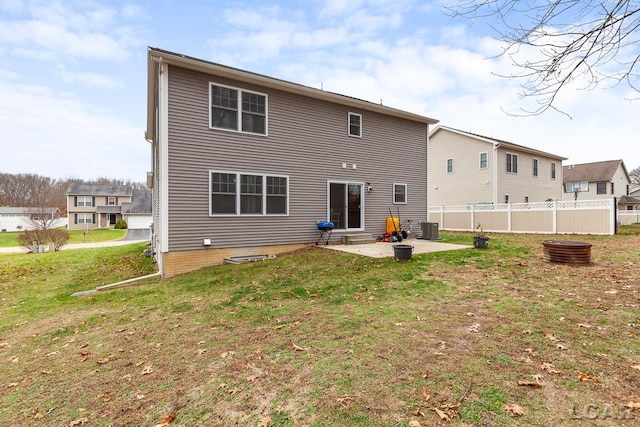 rear view of house featuring central air condition unit, a patio area, and a lawn