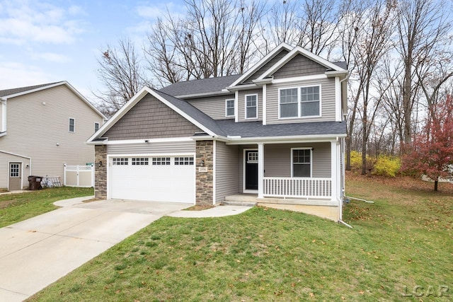 craftsman house featuring a garage, covered porch, and a front lawn