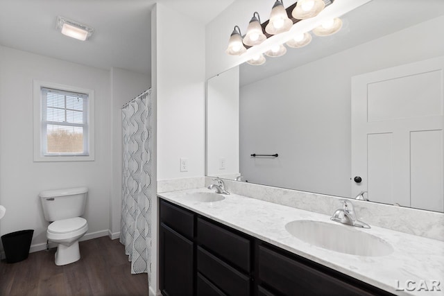 bathroom with vanity, wood-type flooring, and toilet