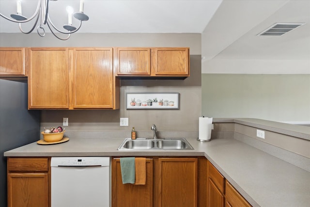 kitchen featuring stainless steel refrigerator, sink, hanging light fixtures, an inviting chandelier, and white dishwasher