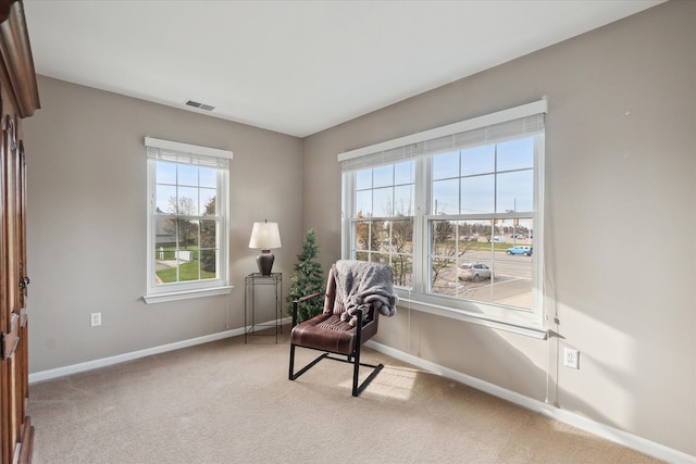 sitting room featuring light colored carpet