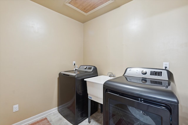 laundry area with washer and clothes dryer and sink