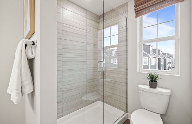 bathroom featuring walk in shower and toilet