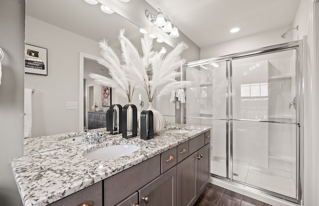 bathroom featuring vanity, hardwood / wood-style floors, and a shower with shower door