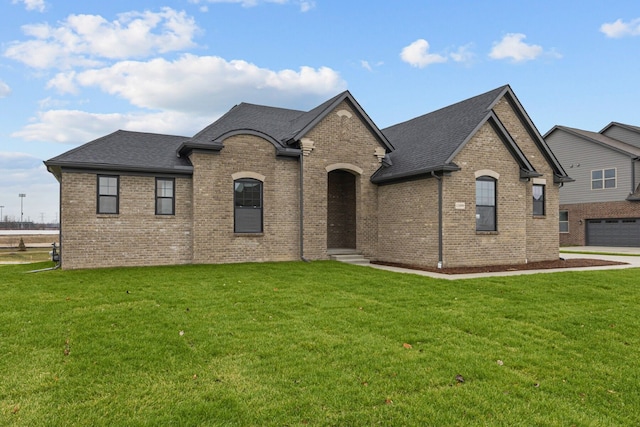 french provincial home with a front yard