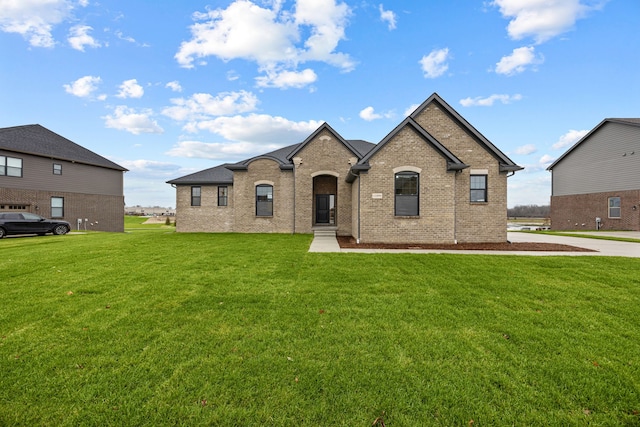 french country home featuring a front lawn