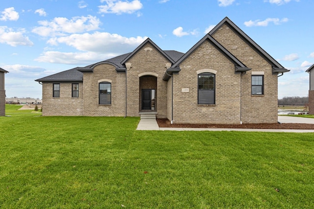 french provincial home featuring a front lawn