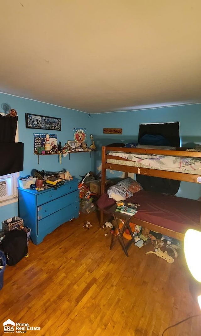 bedroom with hardwood / wood-style flooring