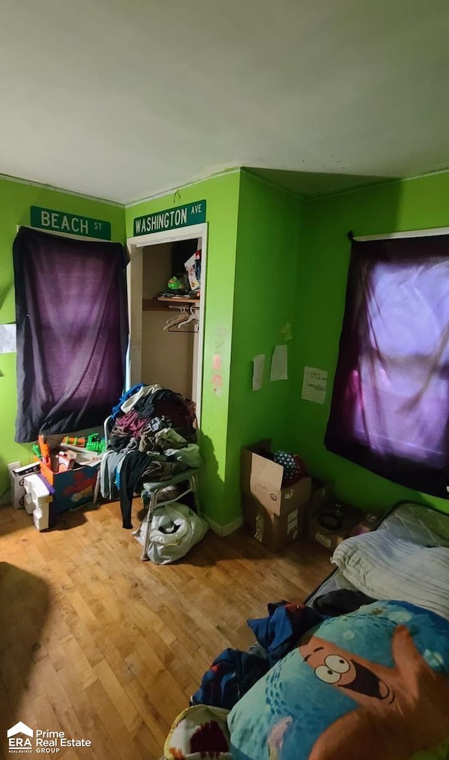 bedroom featuring wood-type flooring and a closet