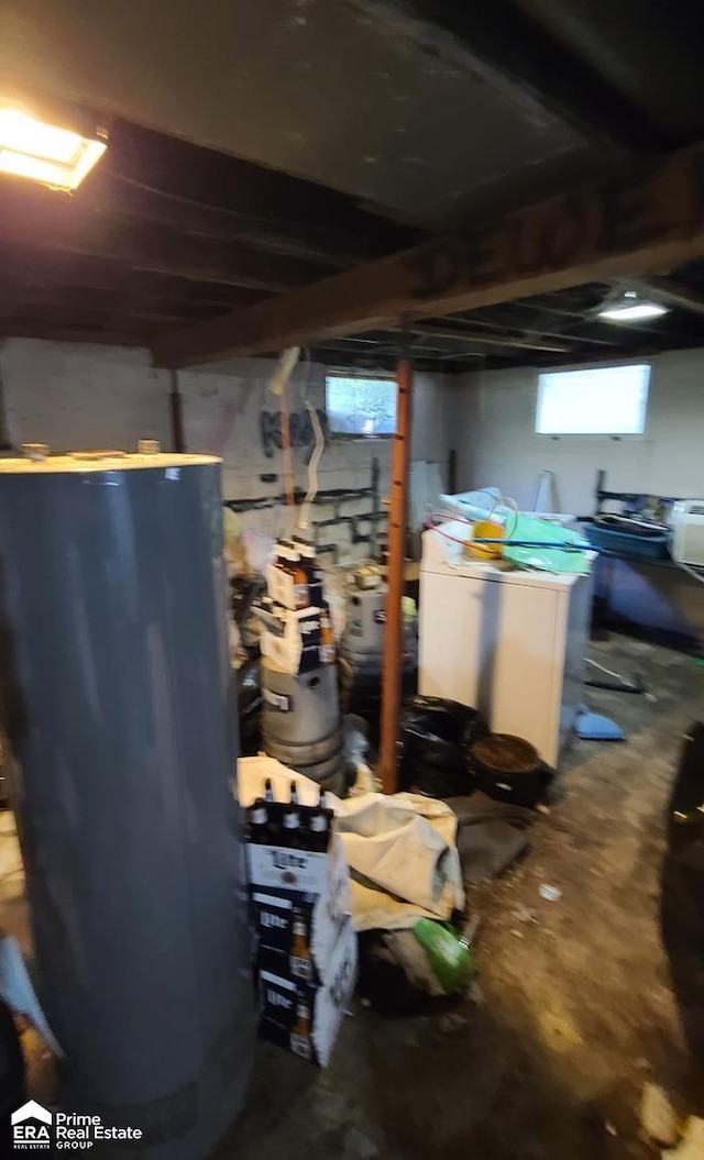 interior space with plenty of natural light, gas water heater, and washer / dryer