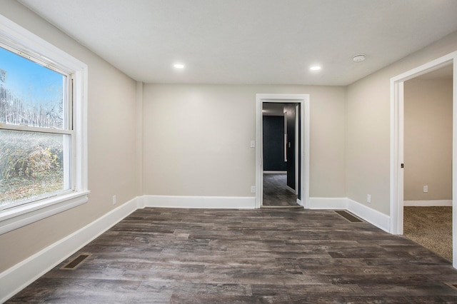 unfurnished room featuring dark hardwood / wood-style flooring