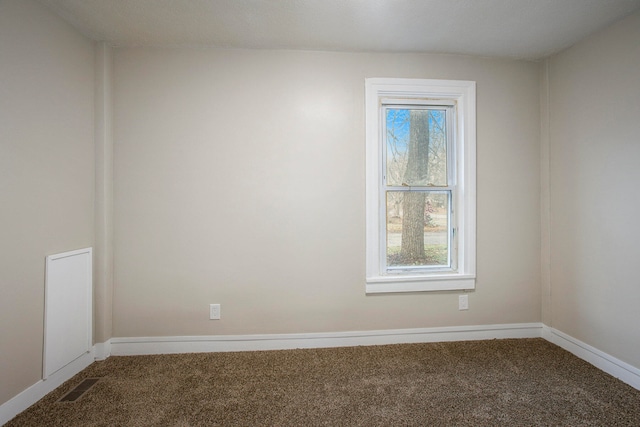 carpeted spare room featuring plenty of natural light