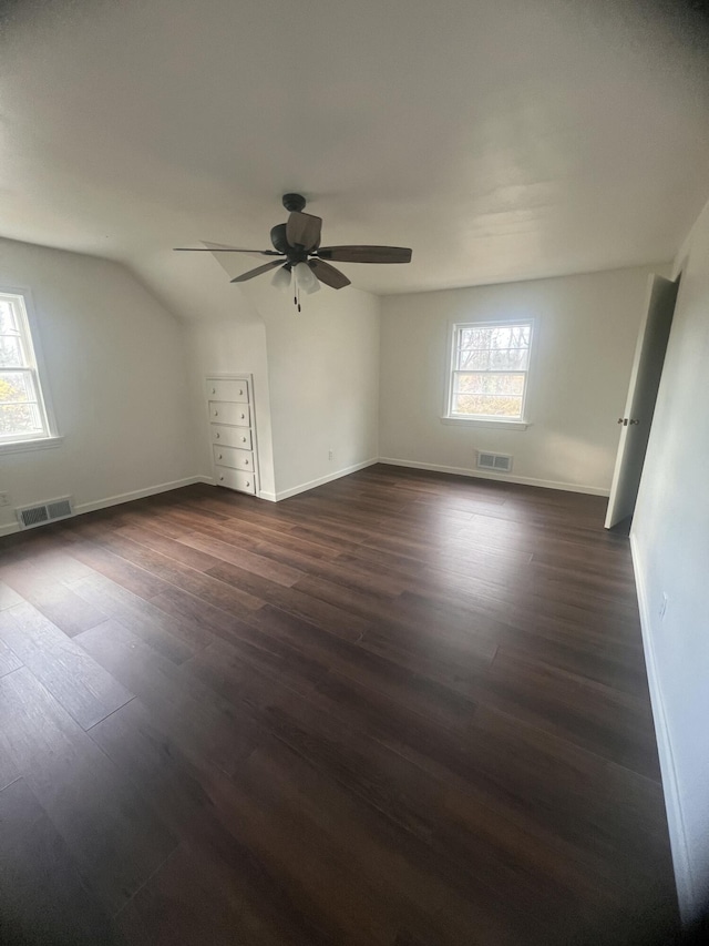 1060 Cross St, Saginaw, MI 48602 - spare room featuring dark wood-type flooring, a ceiling fan, baseboards, and lofted ceiling