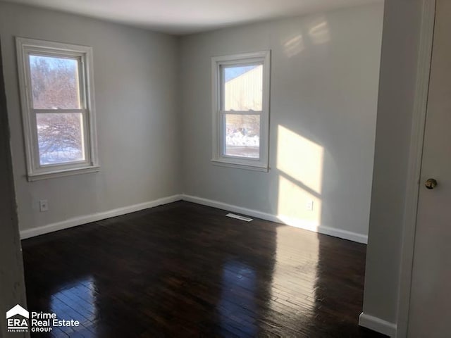 1404 E Kurtz Ave, Flint, MI 48505 - unfurnished room featuring plenty of natural light, hardwood / wood-style flooring, and baseboards