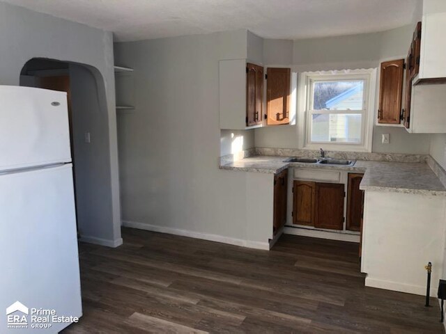 1404 E Kurtz Ave, Flint, MI 48505 - kitchen with freestanding refrigerator, a sink, dark wood-style floors, and light countertops