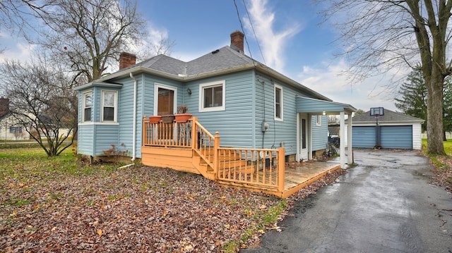 bungalow-style home with an outbuilding and a garage