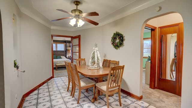 dining area with light colored carpet, ceiling fan, and a healthy amount of sunlight