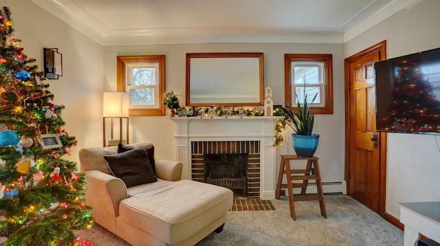 sitting room with carpet flooring, crown molding, a fireplace, and a baseboard radiator