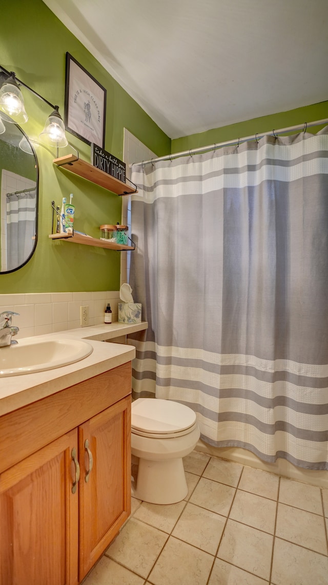 bathroom with tile patterned floors, vanity, toilet, and decorative backsplash