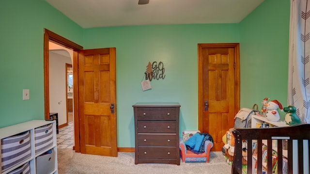 bedroom featuring light carpet and ceiling fan