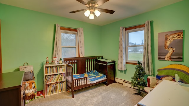 bedroom with baseboard heating, ceiling fan, and carpet