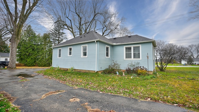 view of home's exterior with a yard