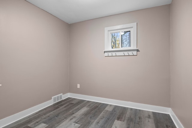 empty room with dark hardwood / wood-style flooring