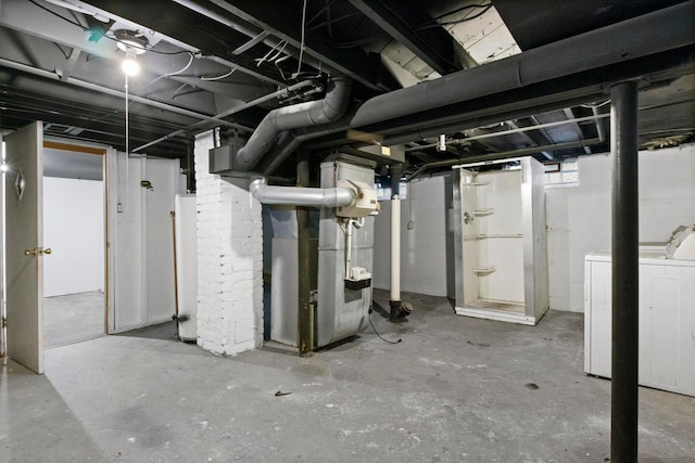 basement featuring washer / clothes dryer and heating unit