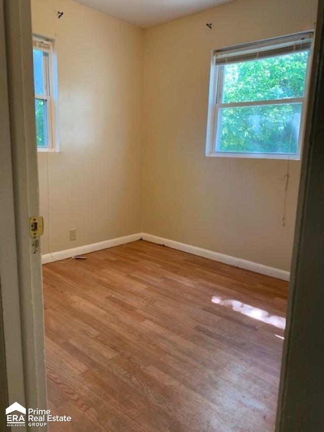 unfurnished room with light hardwood / wood-style flooring