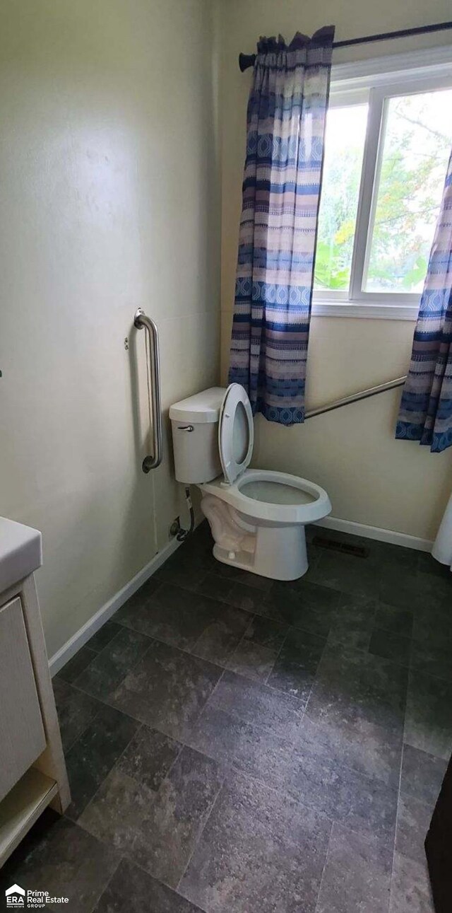 1587 Mcalpine Dr, Mount Morris, MI 48458 - bathroom featuring toilet, vanity, and baseboards
