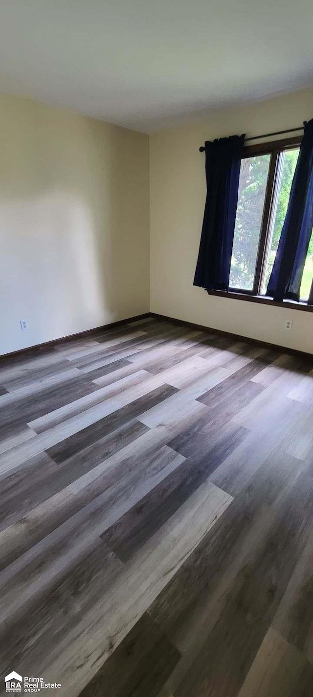 empty room with wood-type flooring