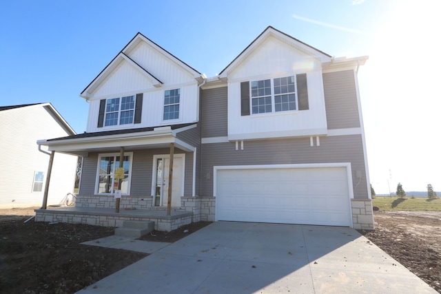 view of front of property with a porch and a garage