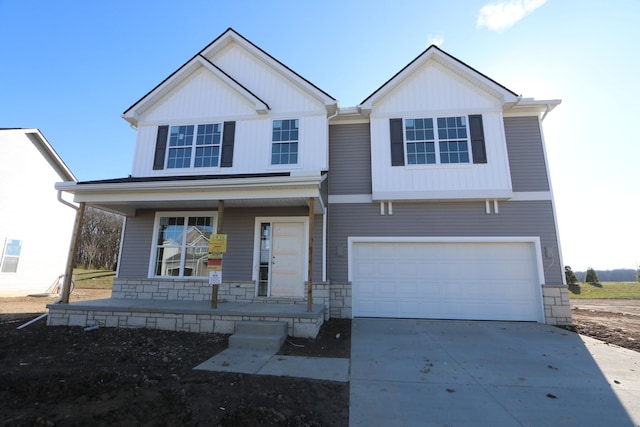 view of front of property with a porch and a garage