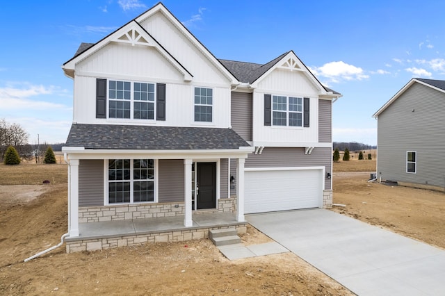 view of front of home with driveway, an attached garage, covered porch, a shingled roof, and board and batten siding