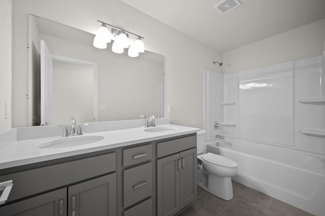 bathroom featuring a sink, visible vents, toilet, and double vanity