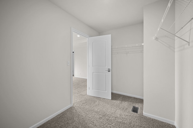 spacious closet featuring visible vents and carpet flooring