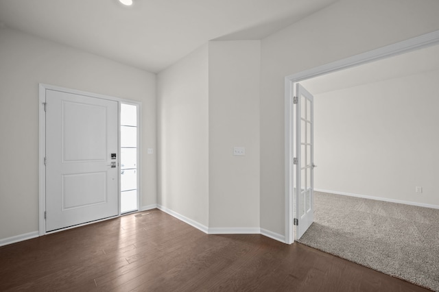 entryway with dark wood-style floors and baseboards