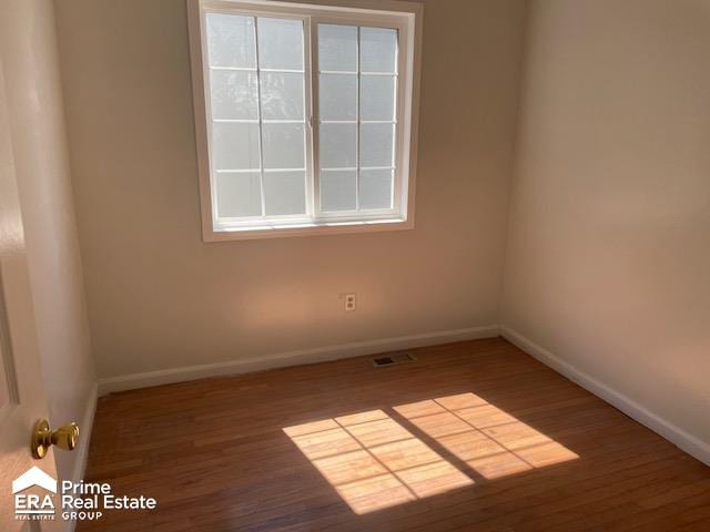 unfurnished room featuring dark hardwood / wood-style floors