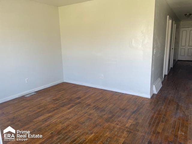 unfurnished room with dark hardwood / wood-style floors