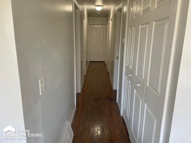 hallway with dark wood-type flooring