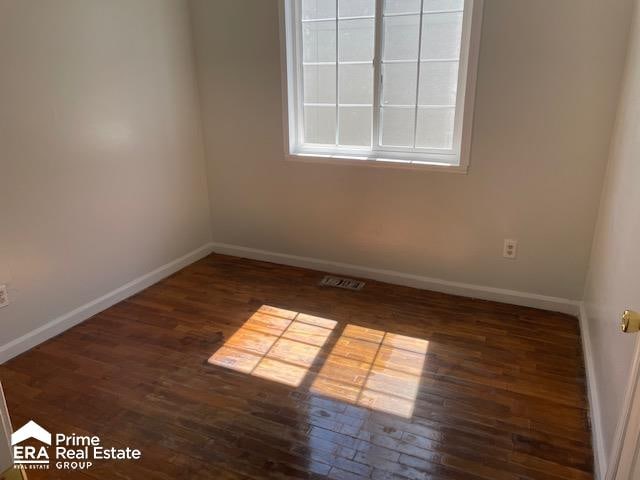 empty room featuring dark wood-type flooring