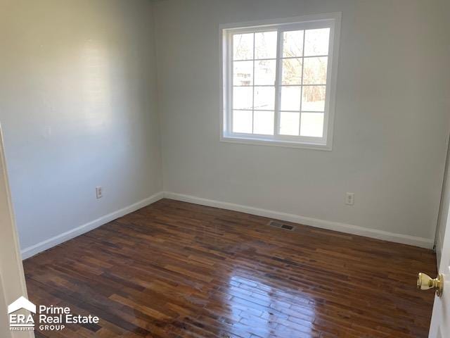 empty room featuring dark hardwood / wood-style flooring