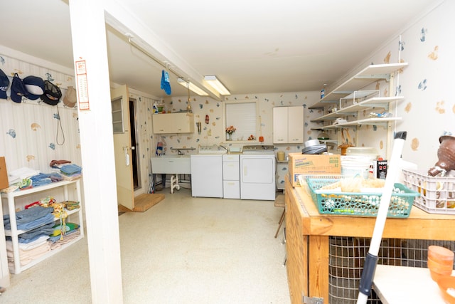 kitchen with independent washer and dryer, wallpapered walls, light floors, a sink, and open shelves