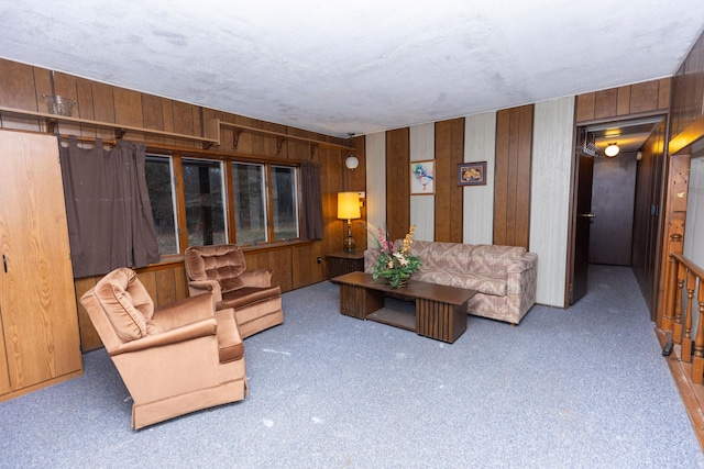 living room featuring carpet floors and wood walls