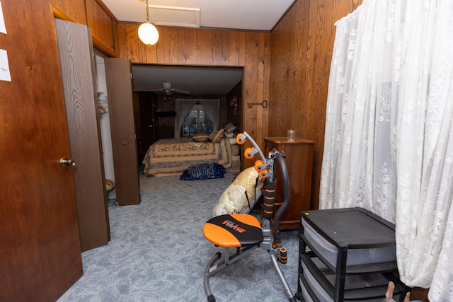 carpeted bedroom with wooden walls