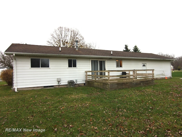 rear view of property with a yard and a wooden deck